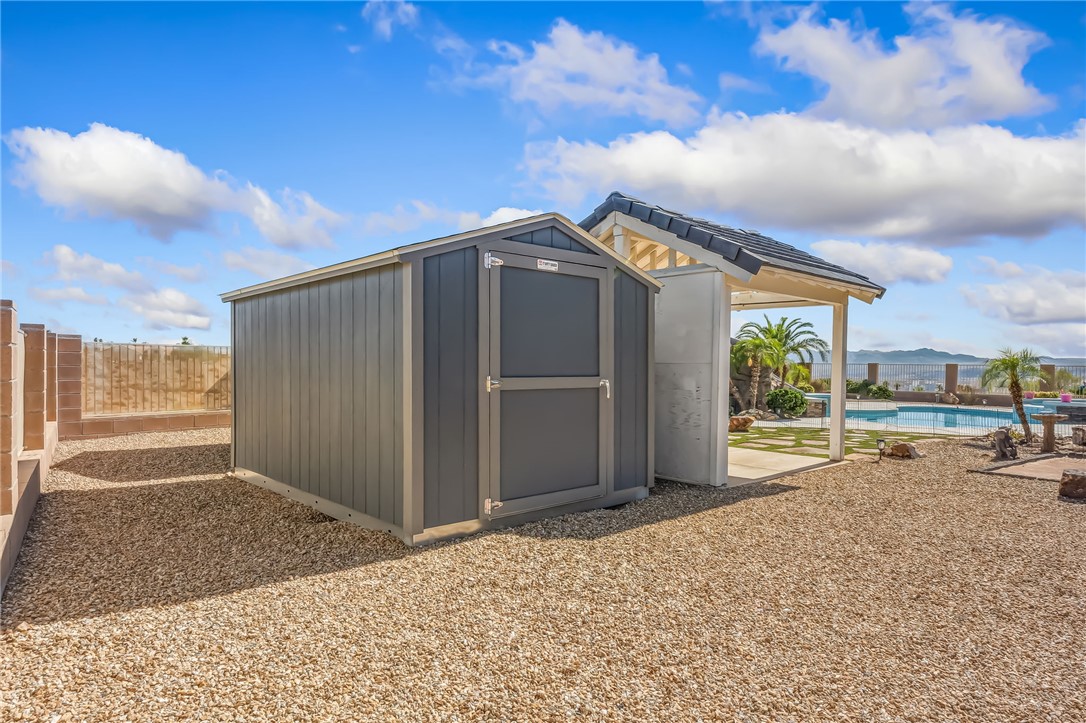 3342 Park Ridge Avenue Bullhead City, AZ 86429 - Photo 67 of 93 This property features a contemporary-style shed, a covered patio area, and an outdoor swimming pool with views of the surrounding landscape