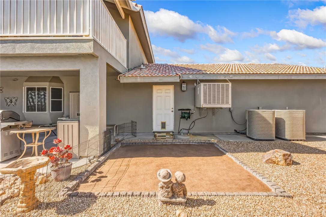 3342 Park Ridge Avenue Bullhead City, AZ 86429 - Photo 68 of 93 The exterior features a covered patio area with a bay window, a paved patio space, and a gravel yard