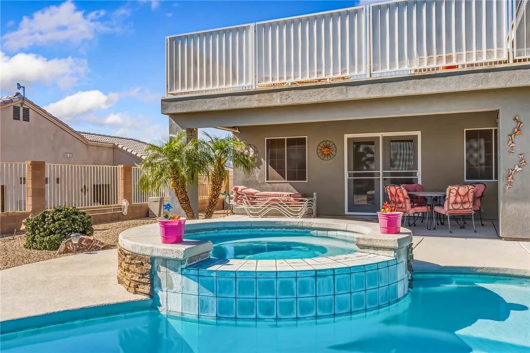 3342 Park Ridge Avenue Bullhead City, AZ 86429 - Photo 70 of 93 The property features a swimming pool with a connected hot tub, tiled in blue
