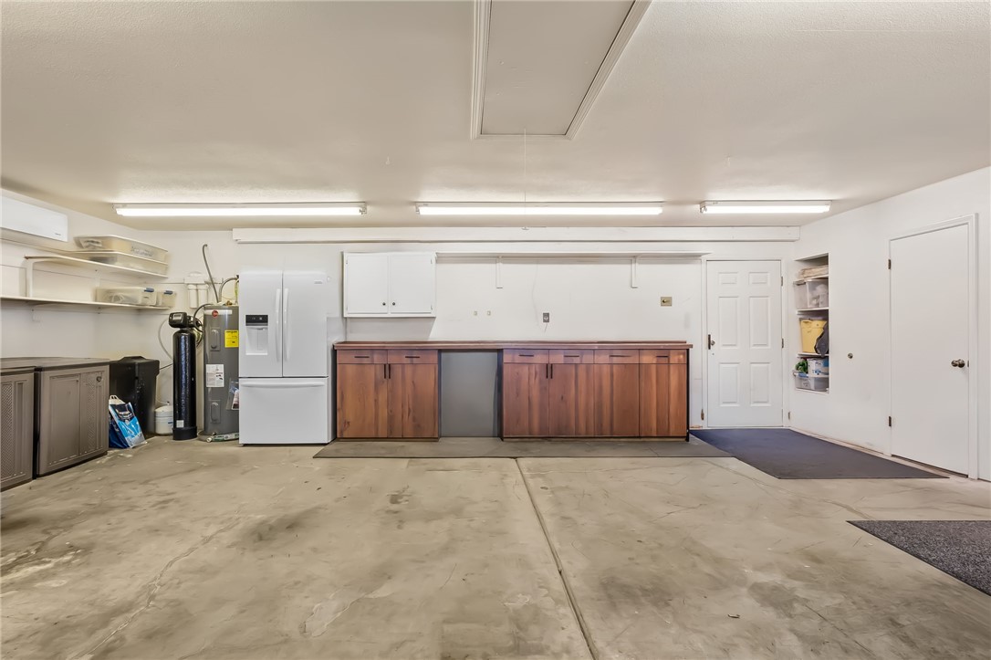 3342 Park Ridge Avenue Bullhead City, AZ 86429 - Photo 73 of 93 The property features a spacious garage with a concrete floor, overhead lighting, and white walls