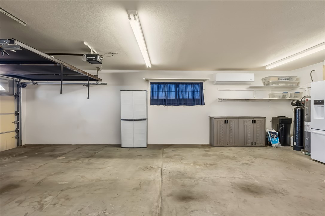3342 Park Ridge Avenue Bullhead City, AZ 86429 - Photo 74 of 93 This garage features a concrete floor, white walls, and bright overhead lighting