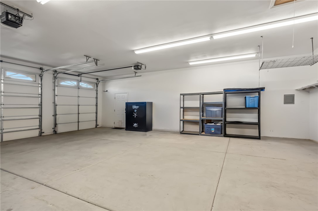 3342 Park Ridge Avenue Bullhead City, AZ 86429 - Photo 78 of 93 This spacious detached garage features two large overhead doors, a white door, and overhead lighting