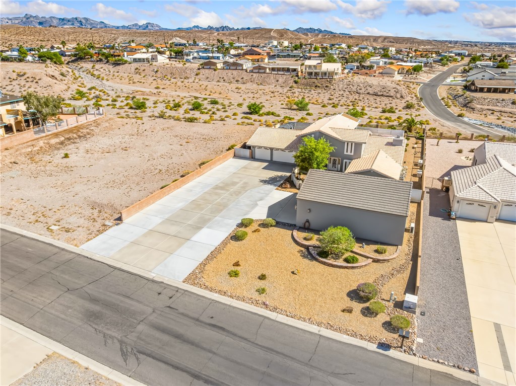3342 Park Ridge Avenue Bullhead City, AZ 86429 - Photo 81 of 93 The property features a large driveway leading to the main residence and an additional structure, with a landscaped front yard