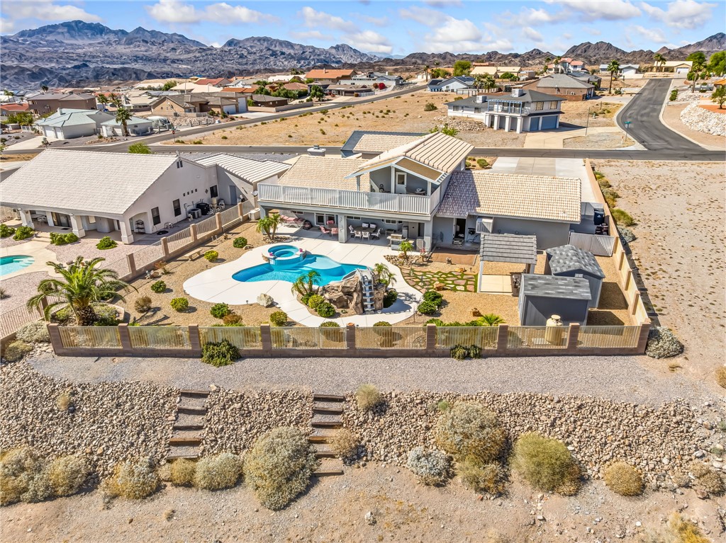 3342 Park Ridge Avenue Bullhead City, AZ 86429 - Photo 83 of 93 The property includes a fenced backyard with a pool, spa, and mature palm trees