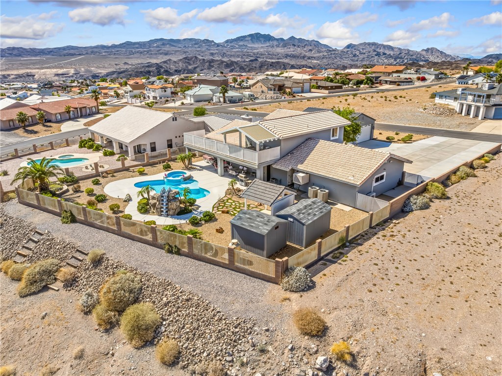 3342 Park Ridge Avenue Bullhead City, AZ 86429 - Photo 84 of 93 This property features a two-story residence with a balcony, a large pool with a slide, and a separate second pool
