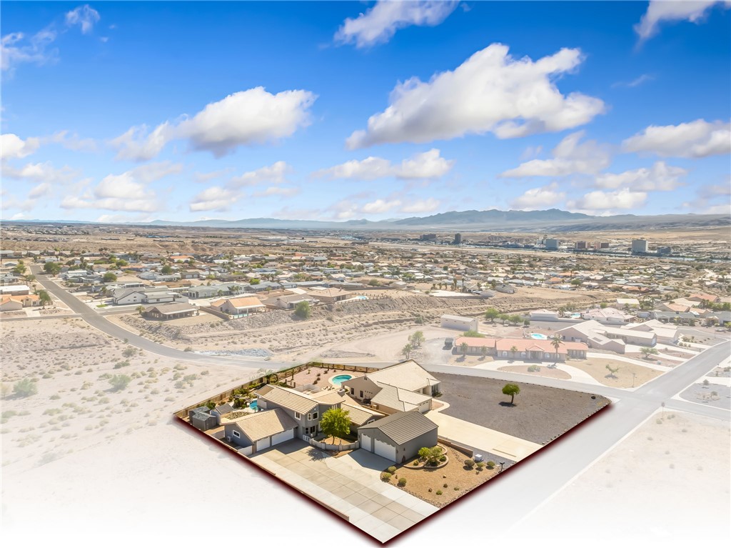 3342 Park Ridge Avenue Bullhead City, AZ 86429 - Photo 89 of 93 Aerial view of the property showcasing a swimming pool, paved driveway, and established landscaping