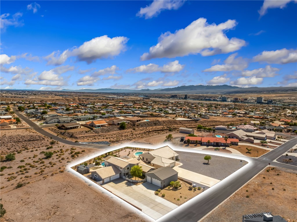 3342 Park Ridge Avenue Bullhead City, AZ 86429 - Photo 90 of 93 Aerial view of the property, featuring a large lot, a swimming pool, and a paved driveway leading to a two-car garage