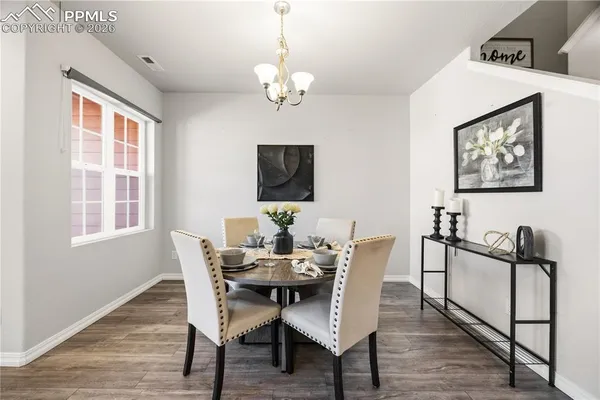 a view of a dining room with furniture window and wooden floor