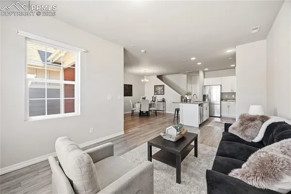 a living room with furniture and wooden floor
