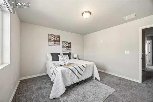 a bed room with a bed and a window