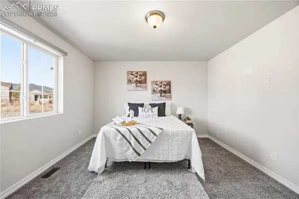 a bedroom with a bed and window