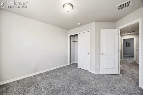 an empty room with closet area