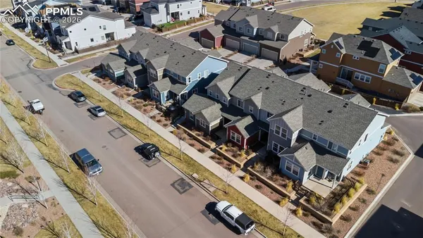 an aerial view of multiple houses with yard