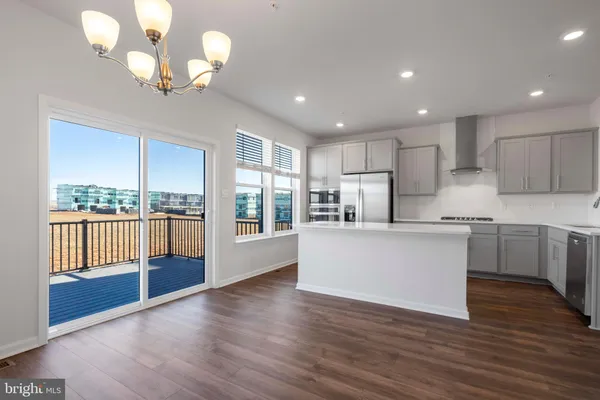 a kitchen with counter top space and wooden floor