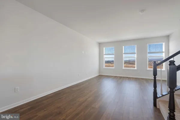 a view of a room with wooden floor and window