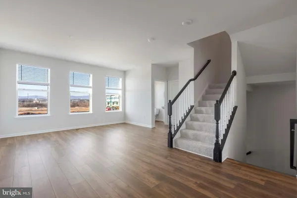 a view of an entryway with wooden floor and stairs