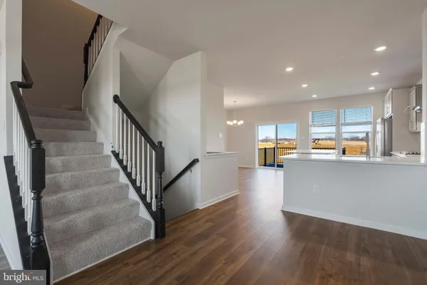 a view of a kitchen with wooden floor and stairs