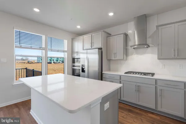 a kitchen with stainless steel appliances a sink stove and refrigerator