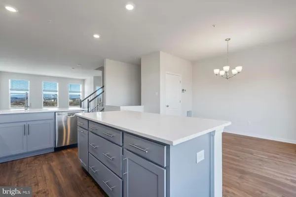 a kitchen with a sink cabinets and wooden floor