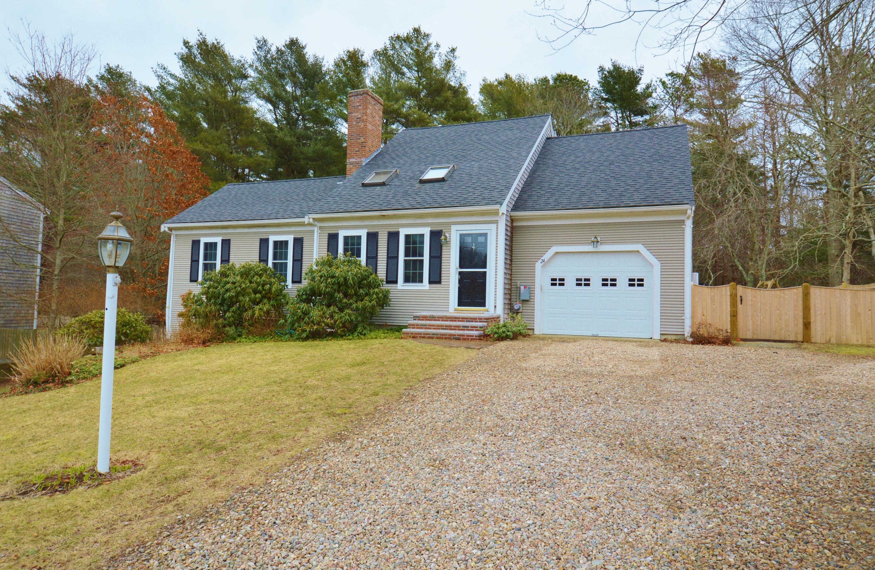 24 Braley Jenkins Road Centerville, MA 02632 - Photo 1 of 20 a front view of a house with a yard and garage