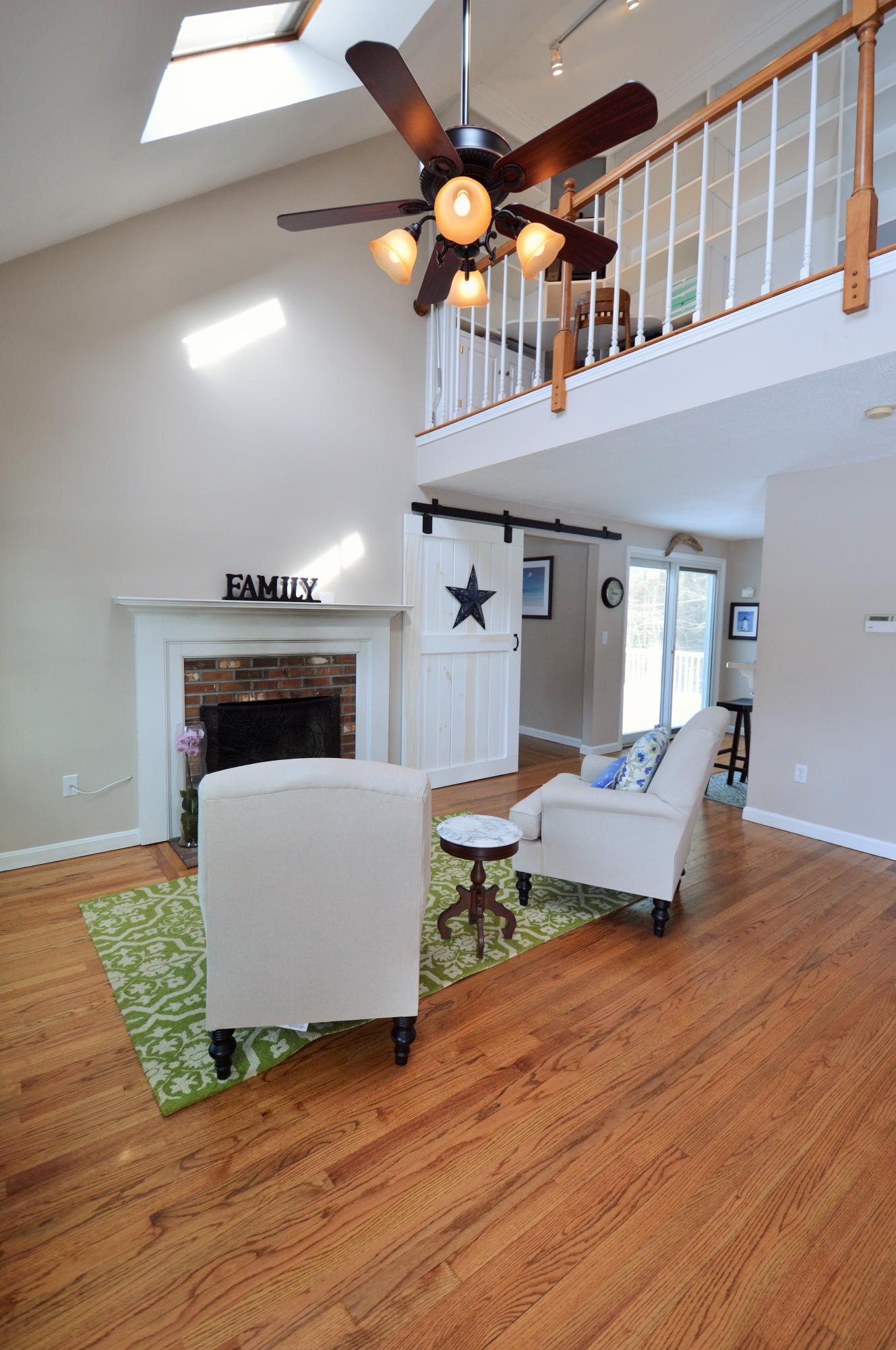 24 Braley Jenkins Road Centerville, MA 02632 - Photo 3 of 20 a living room with furniture and a fireplace