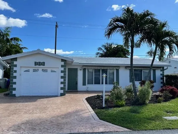 a front view of house with a garden