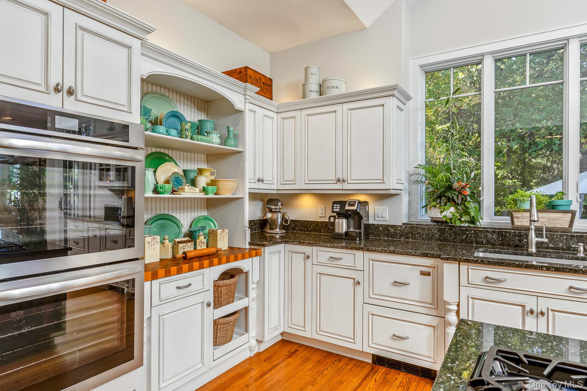 7 Shipyard Lane Setauket, NY 11733 - Photo 17 of 32 a kitchen with white cabinets and window