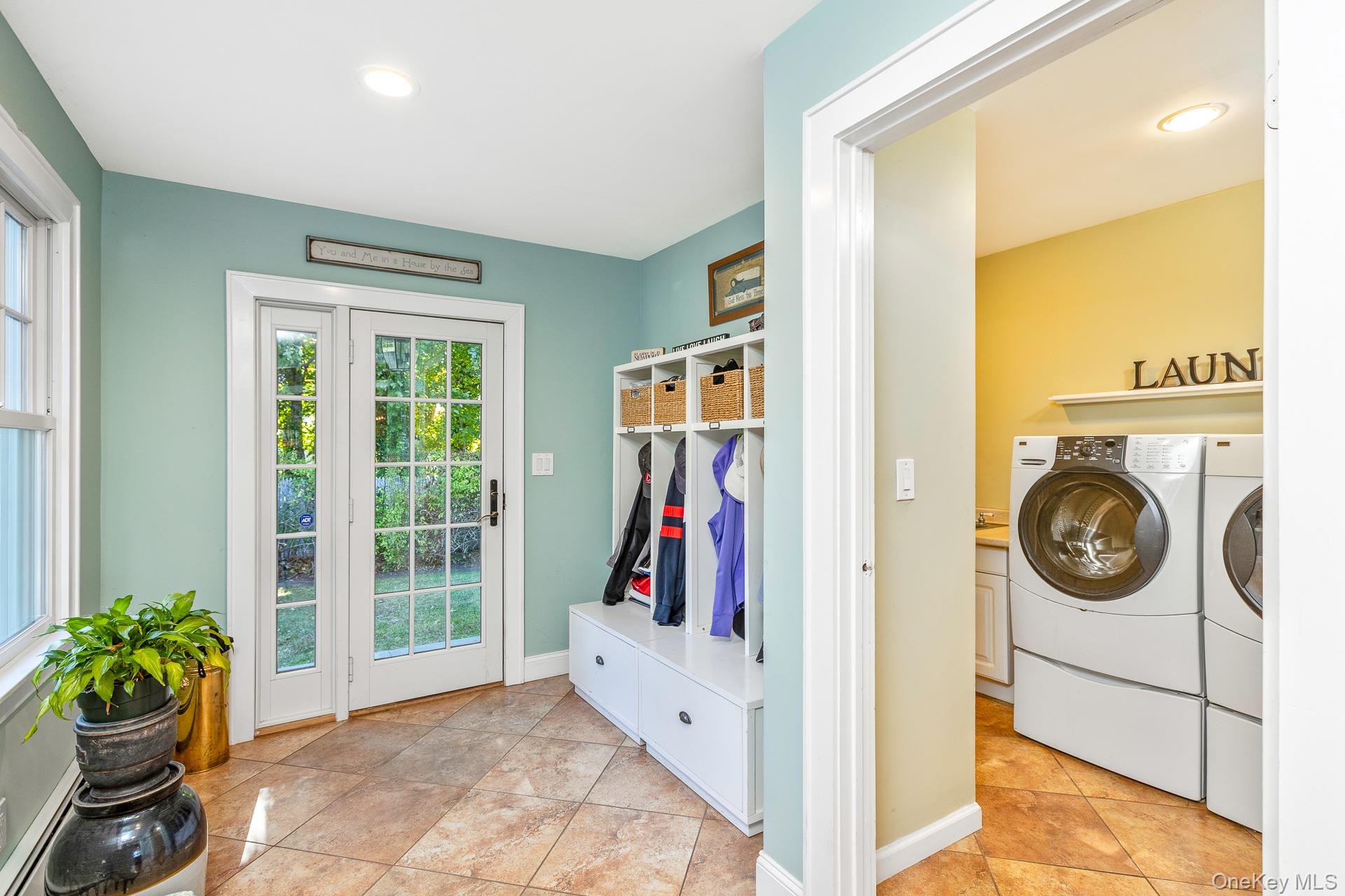 7 Shipyard Lane Setauket, NY 11733 - Photo 19 of 32 a view of a hallway with washer and dryer