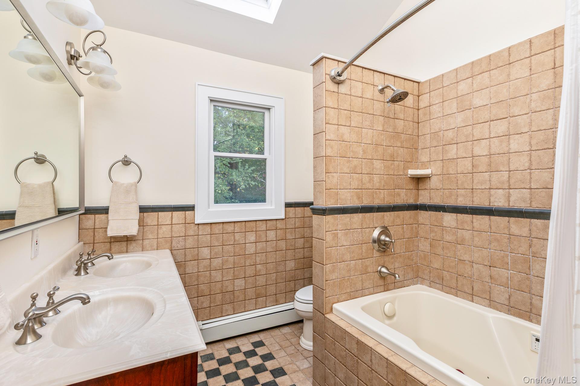 7 Shipyard Lane Setauket, NY 11733 - Photo 22 of 32 a bathroom with a sink and a bathtub