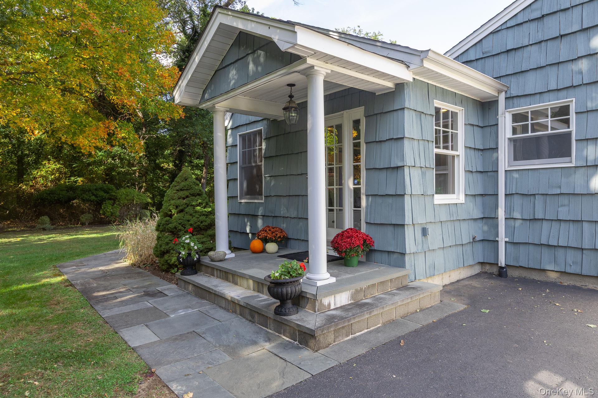 7 Shipyard Lane Setauket, NY 11733 - Photo 28 of 32 a view of brick house with a yard and large tree