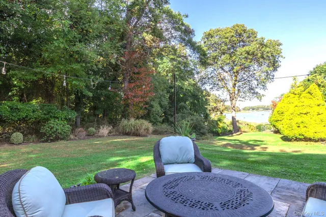 a view of a table and chairs in backyard