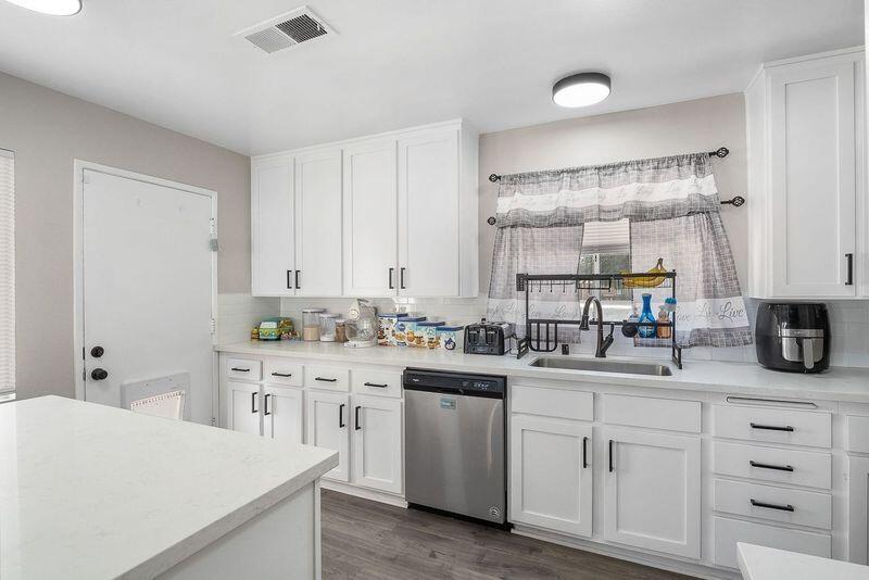 1833 Jenner Street Lancaster, CA 93534 - Photo 11 of 31 a kitchen with cabinets appliances a sink and a counter top space