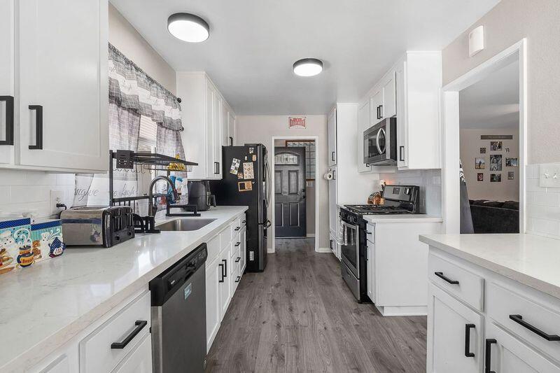 1833 Jenner Street Lancaster, CA 93534 - Photo 12 of 31 a kitchen with cabinets and wooden floor
