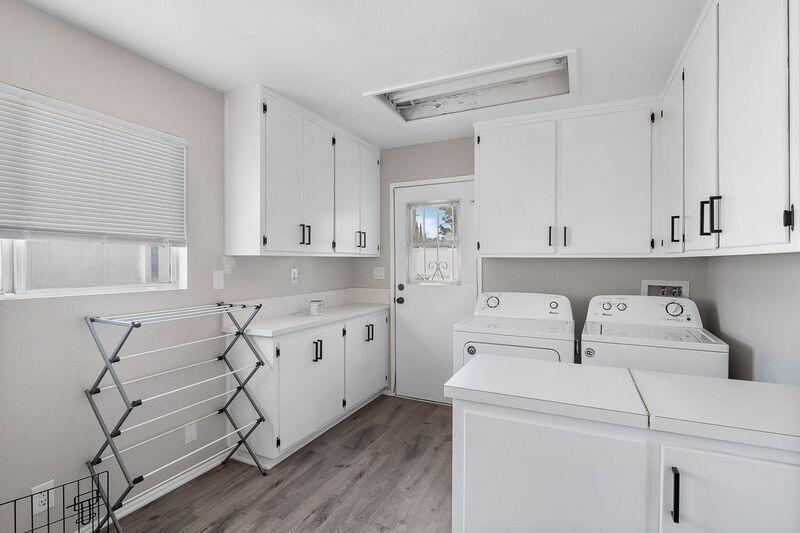 1833 Jenner Street Lancaster, CA 93534 - Photo 19 of 31 a view of cabinets a sink and a stove in a kitchen