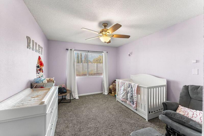 1833 Jenner Street Lancaster, CA 93534 - Photo 20 of 31 a bedroom with a bed and a chandelier