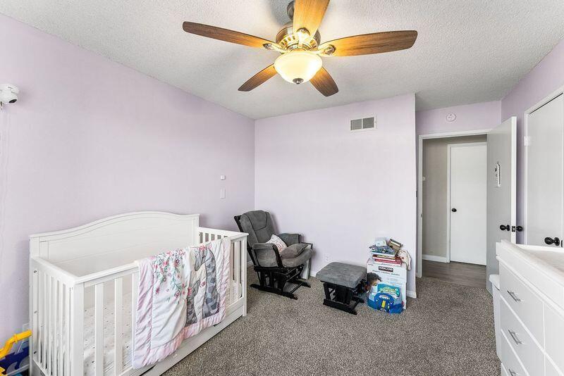 1833 Jenner Street Lancaster, CA 93534 - Photo 22 of 31 a bedroom with a bed and a chandelier