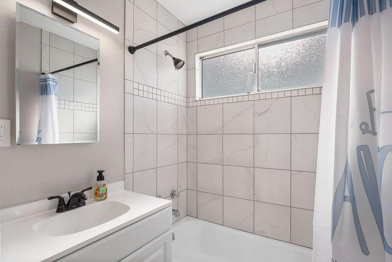 1833 Jenner Street Lancaster, CA 93534 - Photo 23 of 31 a bathroom with a sink and a shower