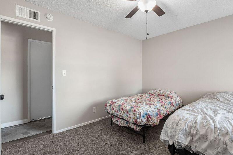 1833 Jenner Street Lancaster, CA 93534 - Photo 27 of 31 a bedroom with two beds and a chandelier