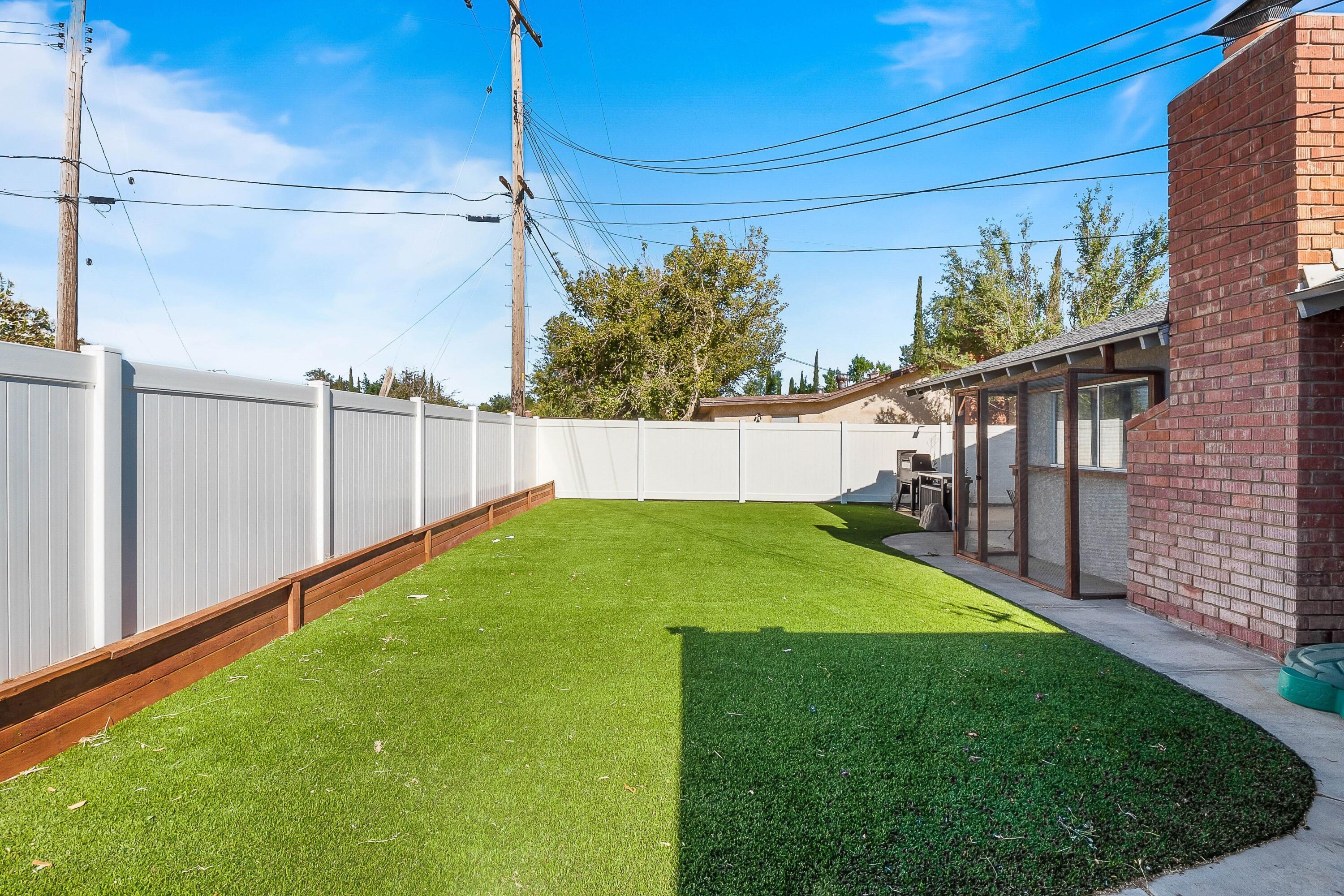 1833 Jenner Street Lancaster, CA 93534 - Photo 30 of 31 a view of a backyard with a small cabin