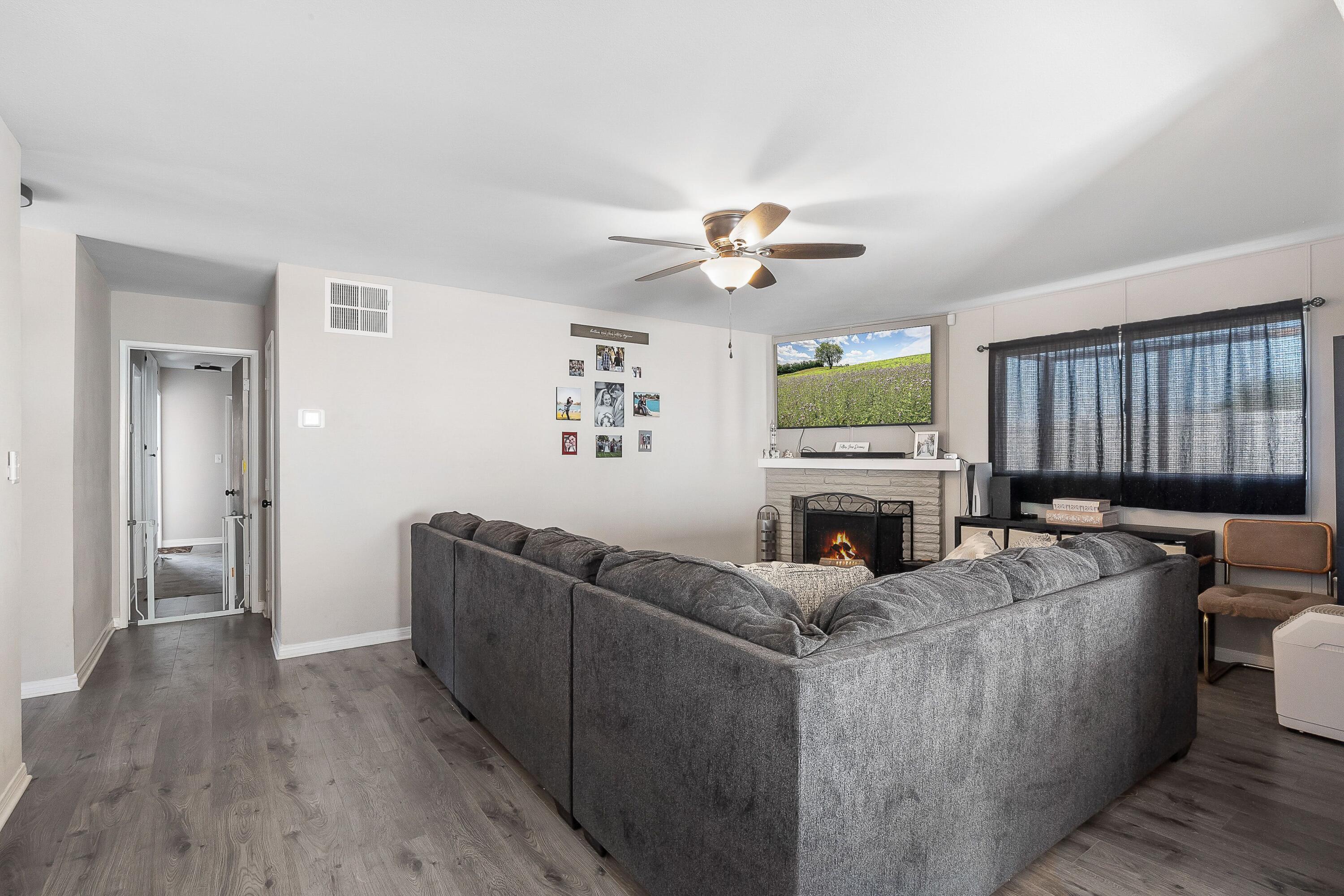 1833 Jenner Street Lancaster, CA 93534 - Photo 9 of 31 a living room with furniture and a fireplace