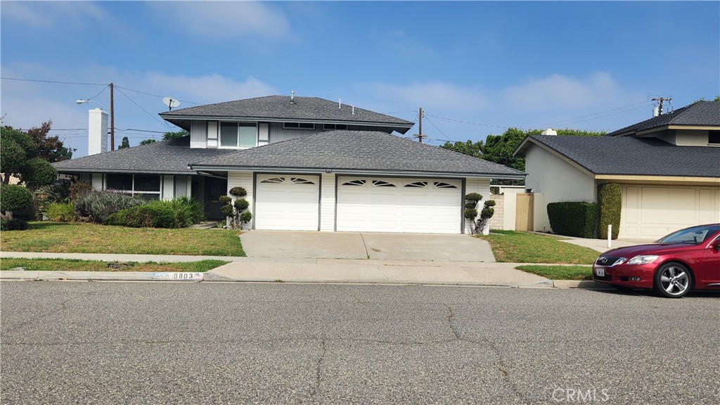 8803 Hummingbird Avenue Fountain Valley, CA 92708 - Photo 1 of 43 a front view of a house with a yard and garage