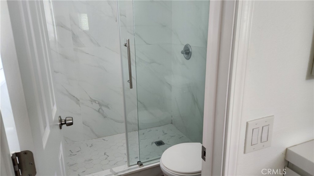 8803 Hummingbird Avenue Fountain Valley, CA 92708 - Photo 14 of 43 a white toilet sitting next to a bathroom sink