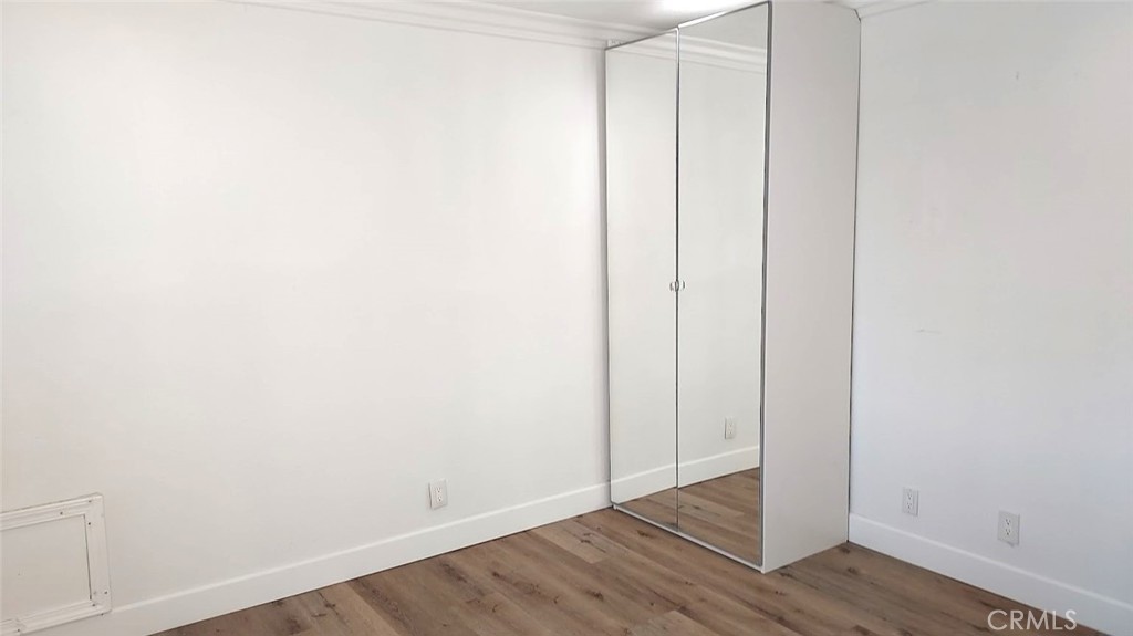 8803 Hummingbird Avenue Fountain Valley, CA 92708 - Photo 15 of 43 a view of an empty room with wooden floor