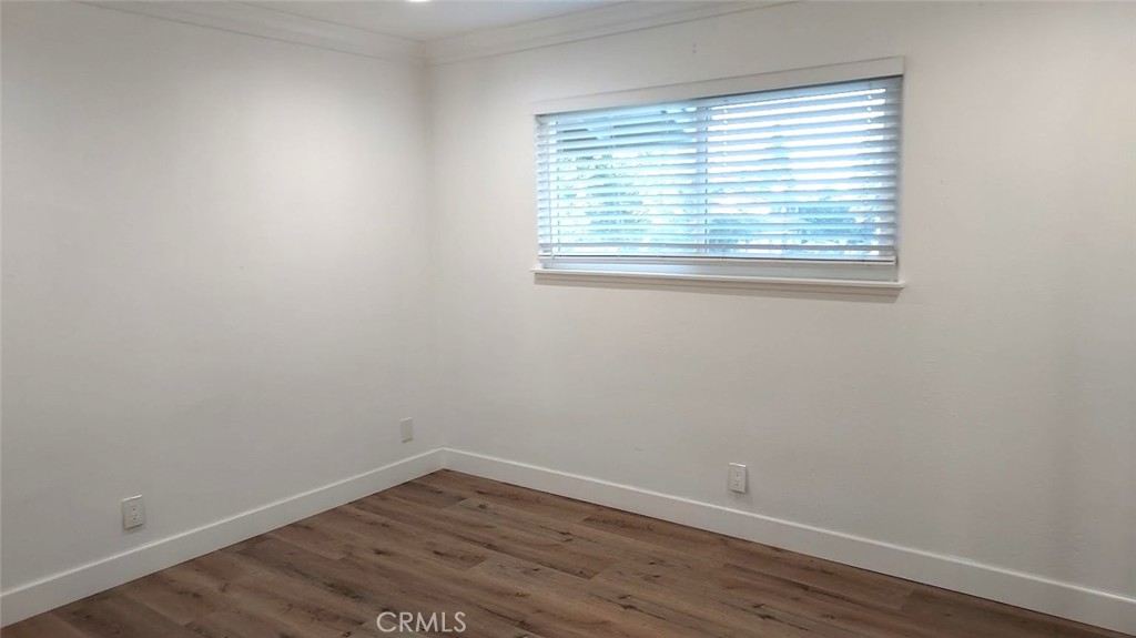 8803 Hummingbird Avenue Fountain Valley, CA 92708 - Photo 18 of 43 wooden floor in an empty room with a window
