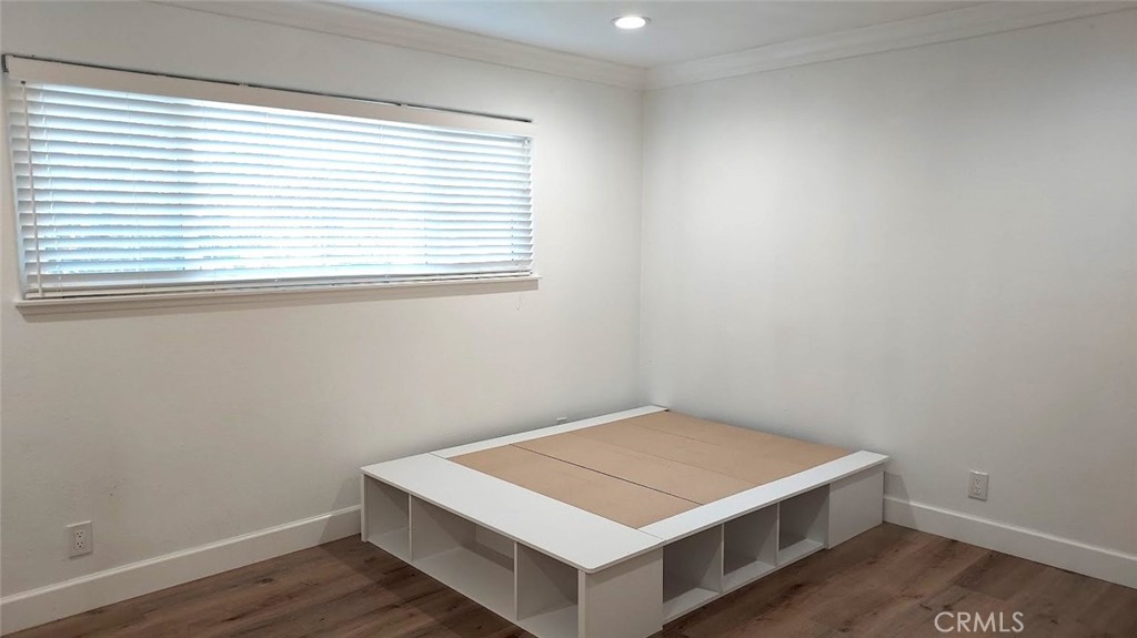 8803 Hummingbird Avenue Fountain Valley, CA 92708 - Photo 22 of 43 a room with a wooden floor and a window