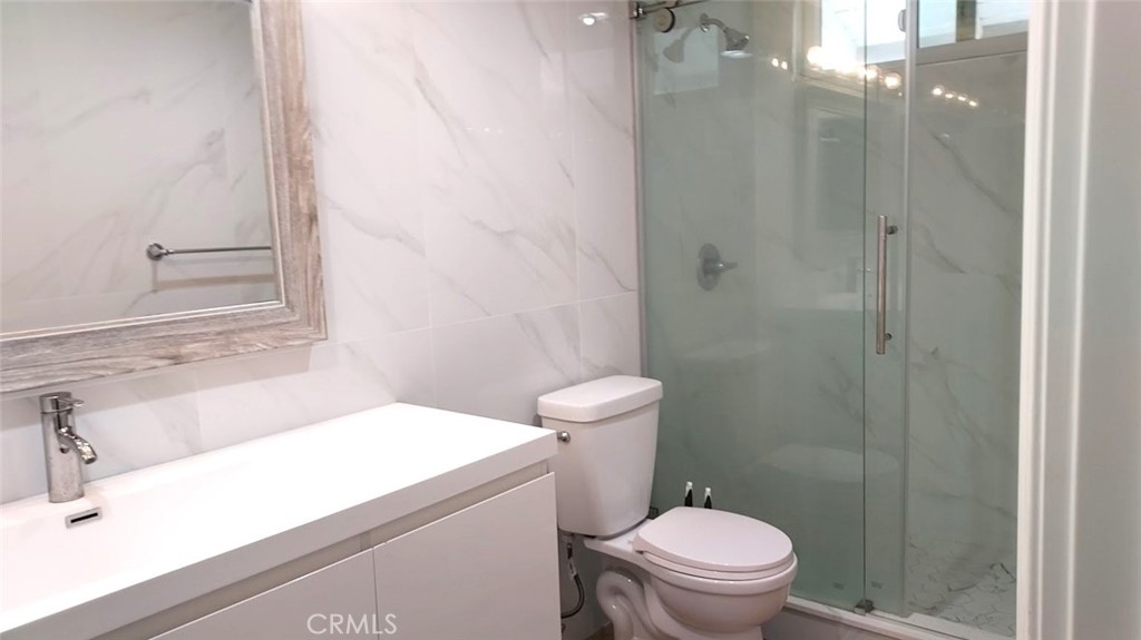 8803 Hummingbird Avenue Fountain Valley, CA 92708 - Photo 23 of 43 a bathroom with a sink a toilet and shower
