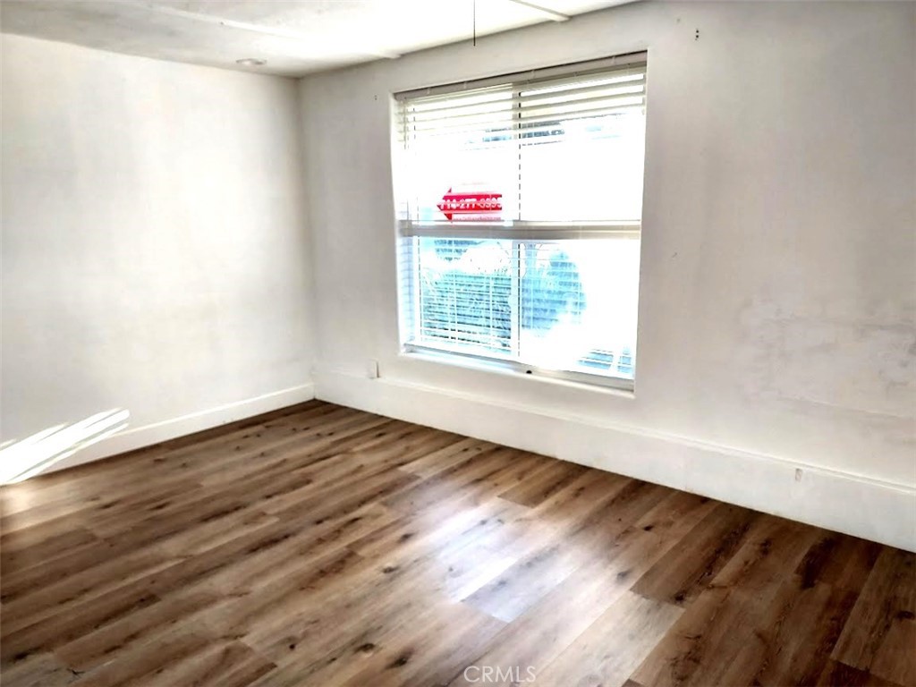 8803 Hummingbird Avenue Fountain Valley, CA 92708 - Photo 25 of 43 a view of an empty room with wooden floor and a window