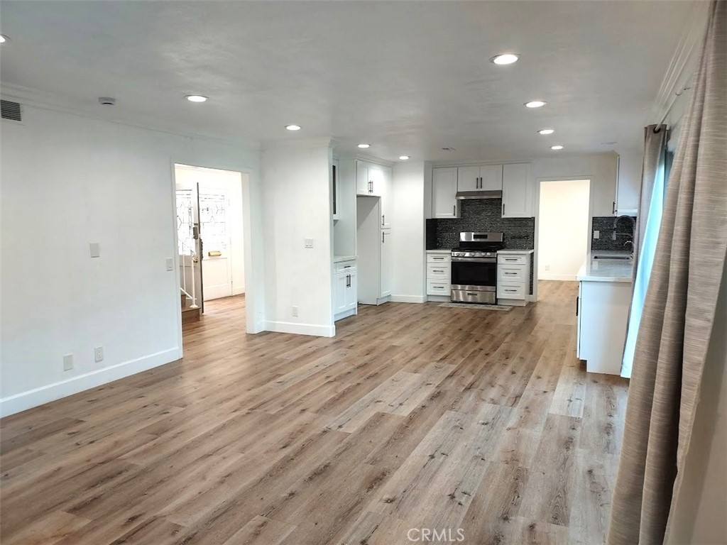 8803 Hummingbird Avenue Fountain Valley, CA 92708 - Photo 31 of 43 a view of kitchen with kitchen island wooden floor appliances and cabinets
