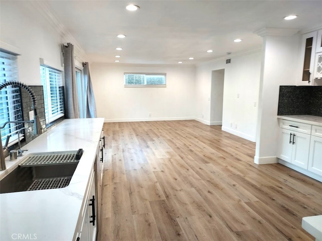 8803 Hummingbird Avenue Fountain Valley, CA 92708 - Photo 33 of 43 a view of a kitchen with wooden floor and a sink