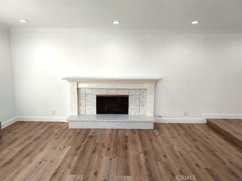 8803 Hummingbird Avenue Fountain Valley, CA 92708 - Photo 8 of 43 a view of an empty room with wooden floor and a fireplace